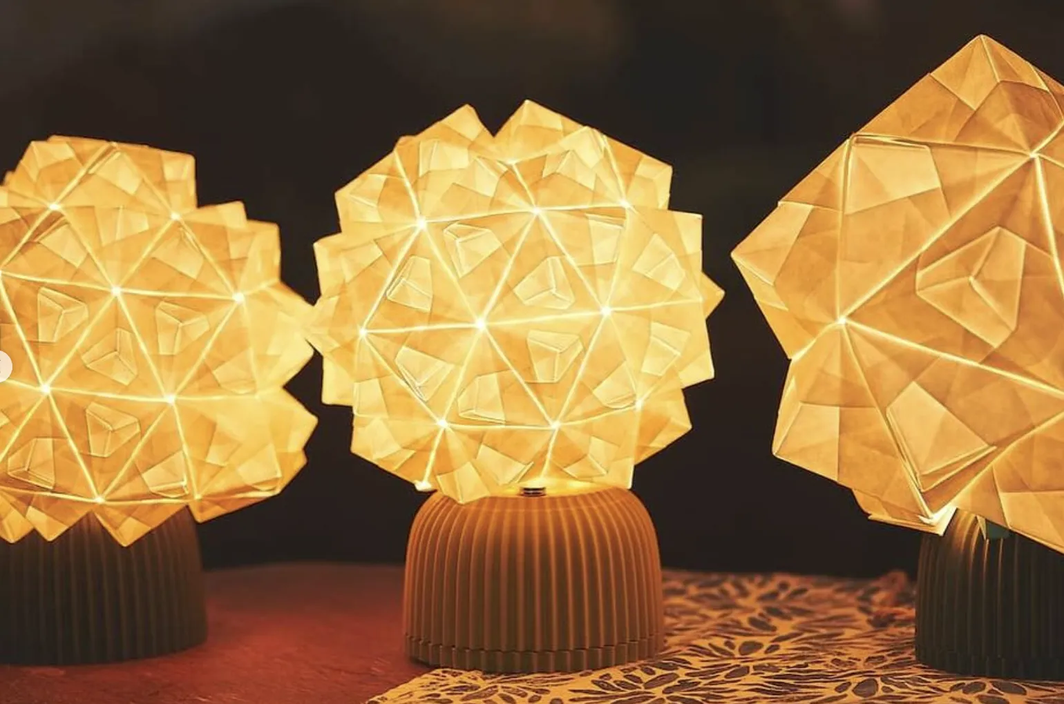 Three illuminated origami lamps
